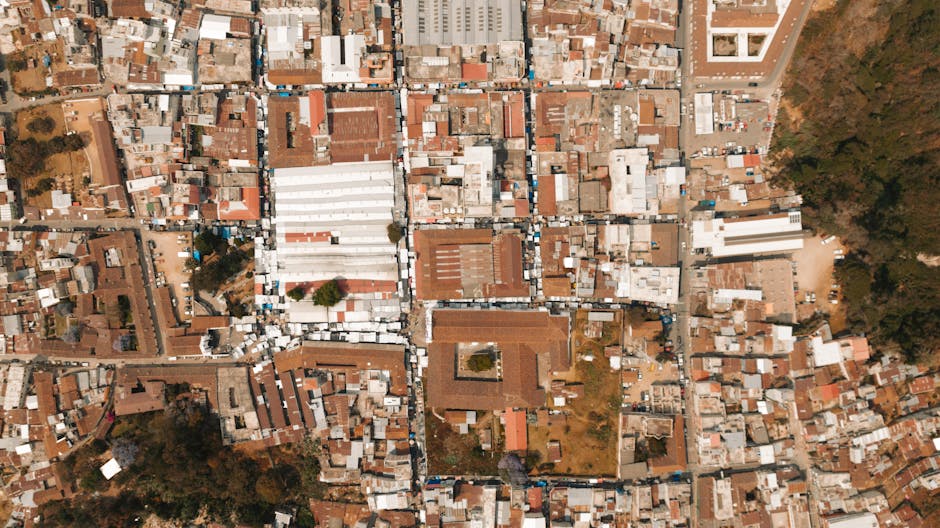 Top-down aerial photo capturing the intricate layout of town rooftops and streets.