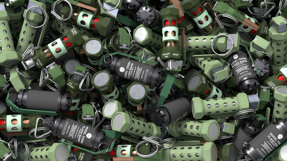 Close-up image of various military flash bang grenades with green and black casing.