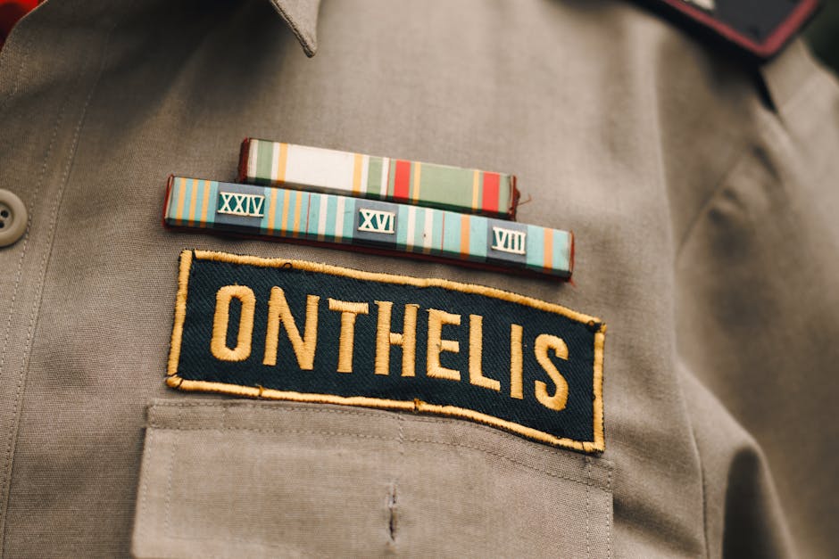 Detailed view of a military uniform highlighting a name tag and colorful service ribbons, symbolizing honor and service.