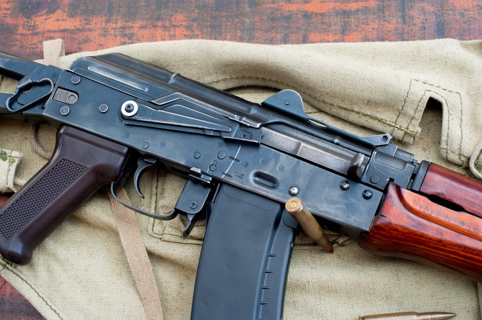 A detailed view of a military rifle with ammunition on a canvas backdrop.